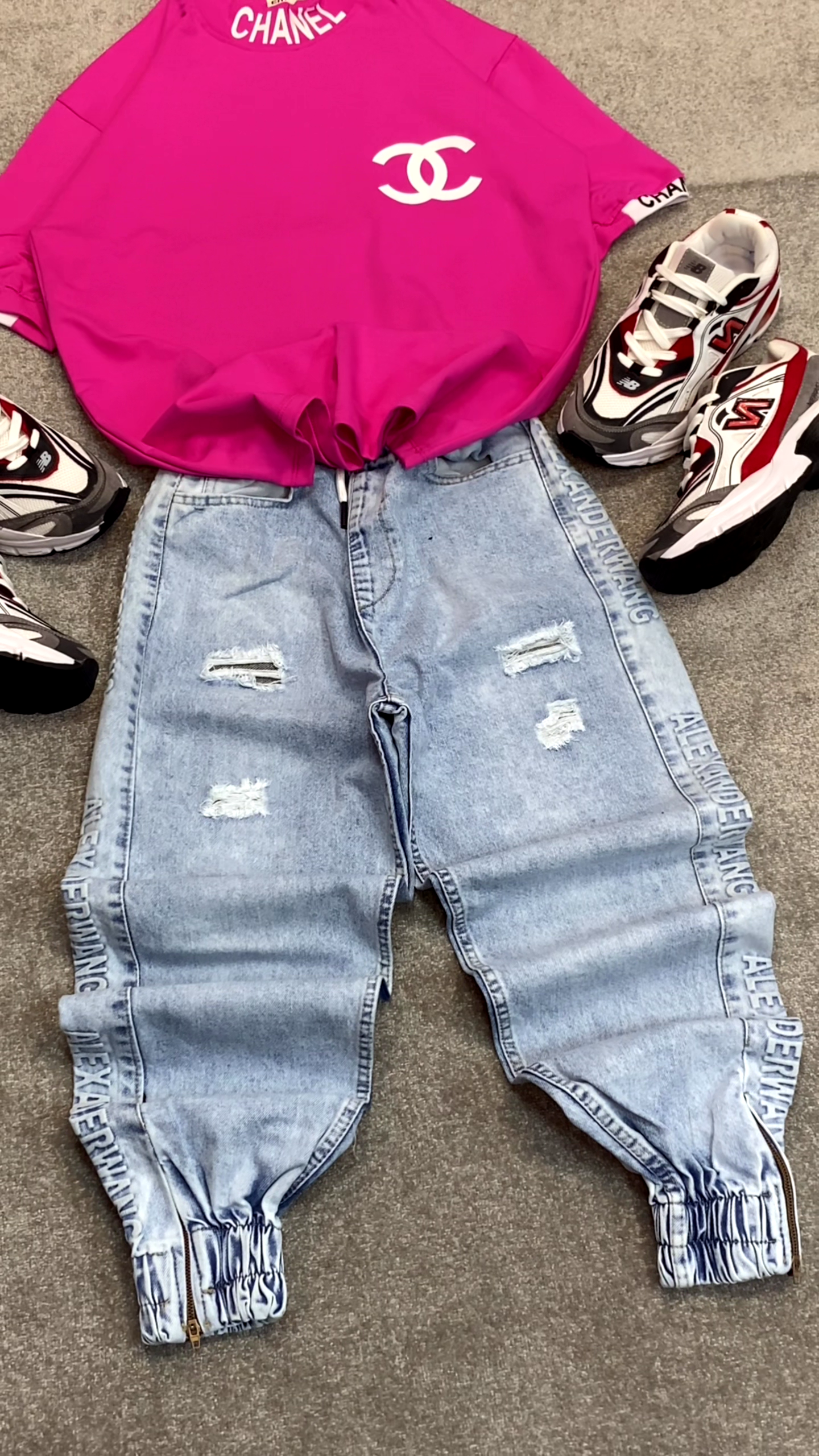 Bright Pink T-Shirt 👕 with Prominent White Logo ✨ + Light Blue Distressed Jeans 👖 + Silver Sneakers 👟 Casual Ensemble