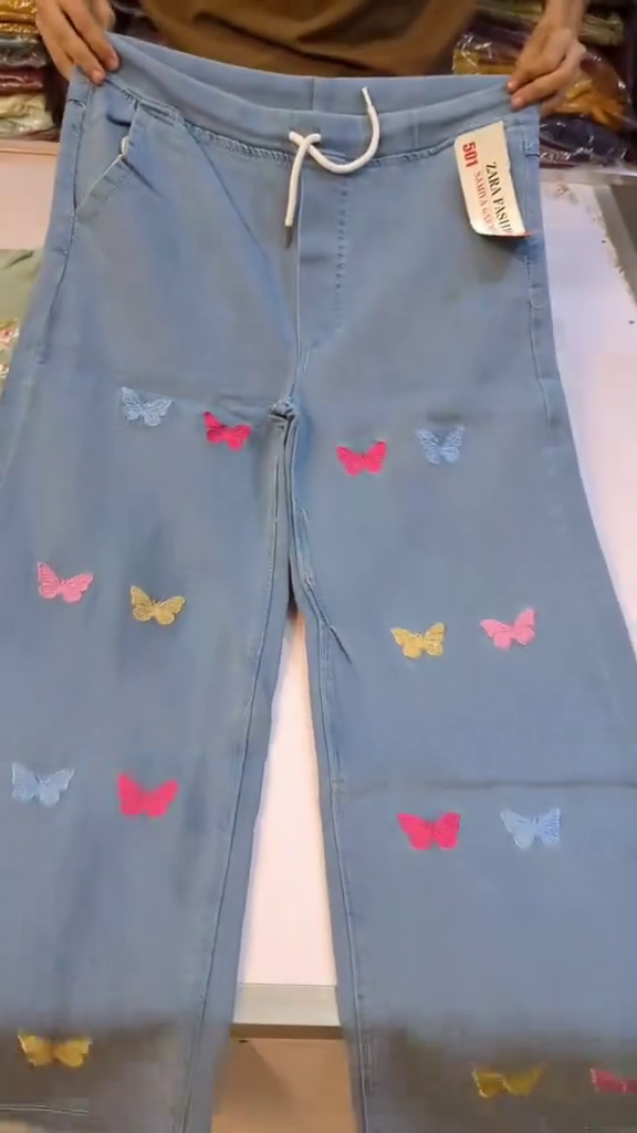 Pastel Sage Green Floral Heavy Embroidered A-Line Kurti Top Paired with Butterfly Motif Light Wash Denim