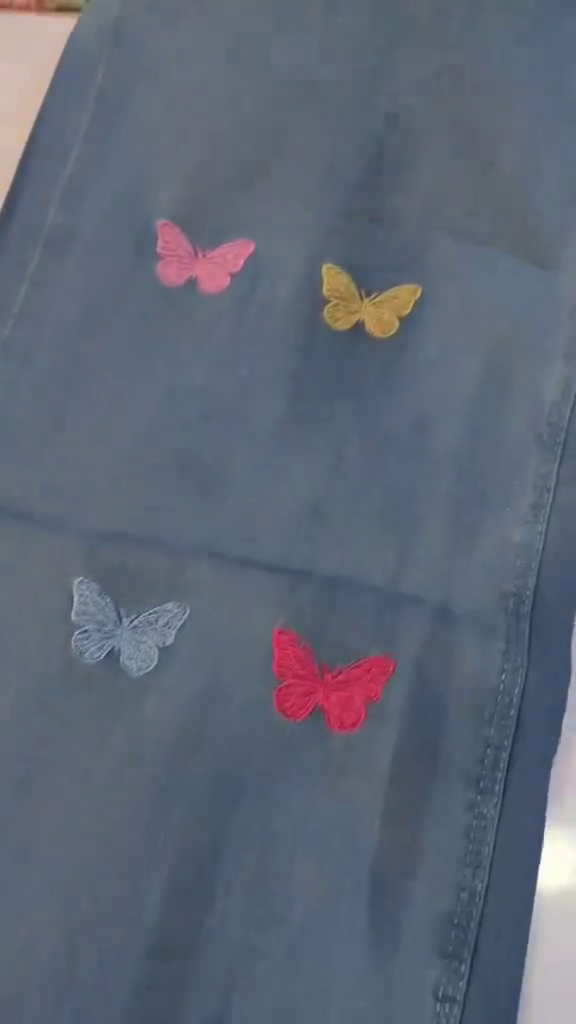 Pastel Sage Green Floral Heavy Embroidered A-Line Kurti Top Paired with Butterfly Motif Light Wash Denim