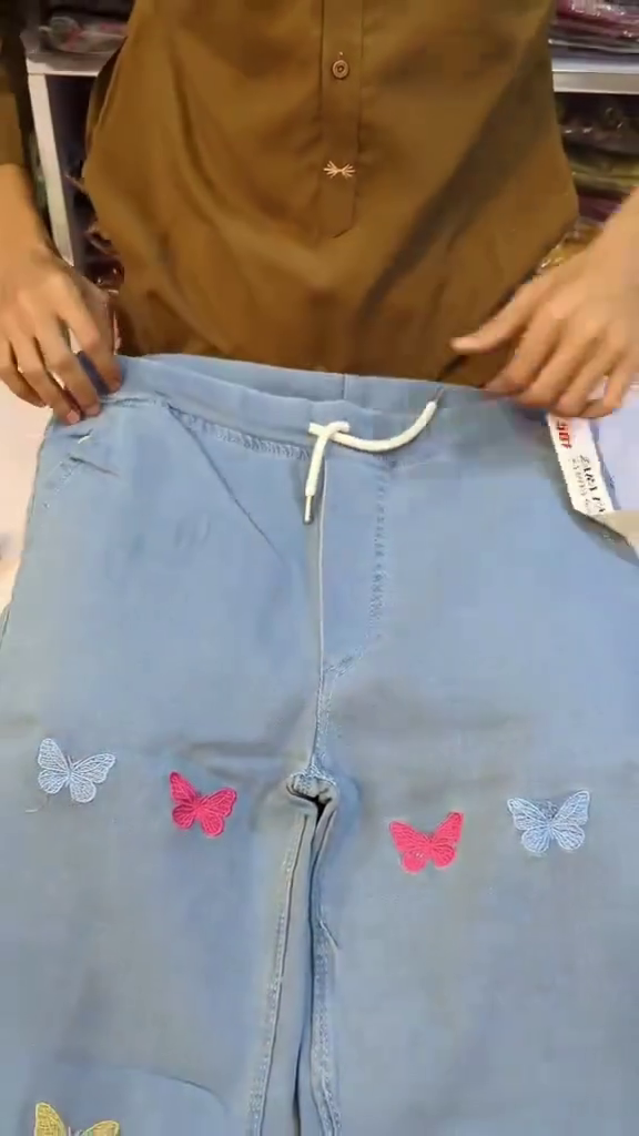 Pastel Sage Green Floral Heavy Embroidered A-Line Kurti Top Paired with Butterfly Motif Light Wash Denim