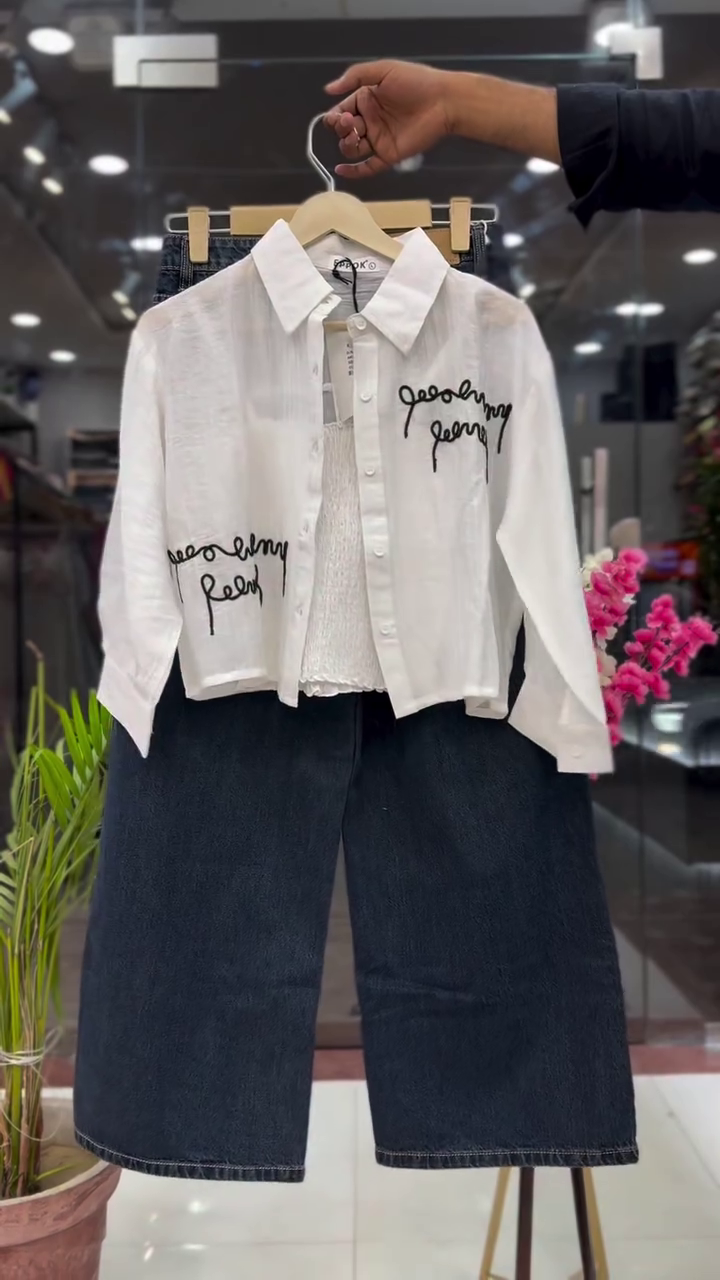 Modern White Cropped Button Down Shirt with Black Script Print Layered Over Inner Top and Dark Blue Wide Leg Denim Set